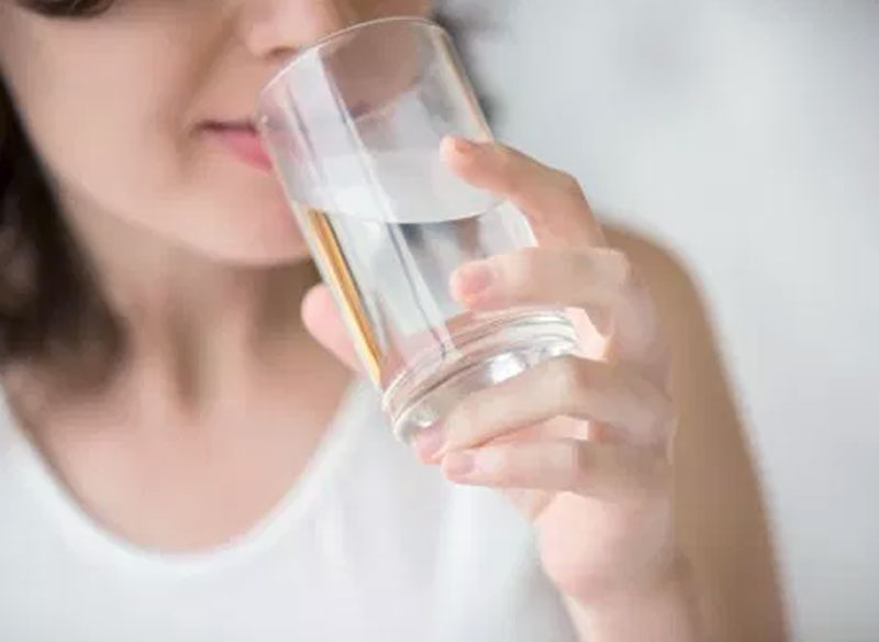Woman drinking indalo alkaline water
